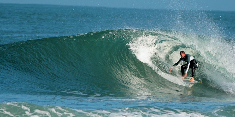 Surfer surfing a tube in Hossegor, France